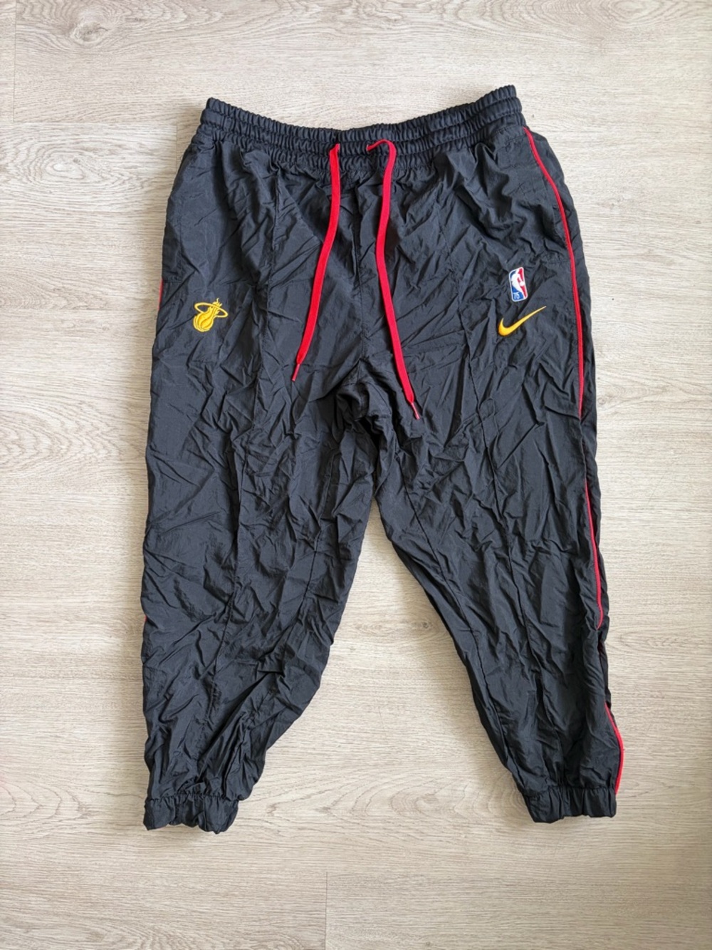Nike NBA 75 Miami Heat Black Joggers with Red Drawstrings and Yellow Logos